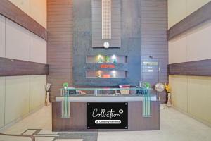 a restaurant with a counter in the middle of a room at Collection O Dhanbad Railway Station Formerly Hotel VIP Residency in Dhanbād