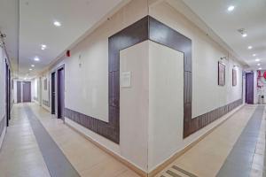 a hallway with a large mirror on the wall at Collection O Dhanbad Railway Station Formerly Hotel VIP Residency in Dhanbād