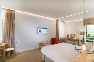Postel nebo postele na pokoji v ubytování NLH FIX | Neighborhood Lifestyle Hotels