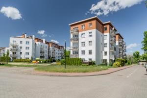 a row of apartment buildings on a street at Apartament Piastowska Elite in Gdańsk