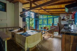 a kitchen with a table in the middle of a room at Kandyan Mist Retreat in Kandy