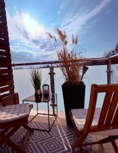 a balcony with two chairs and a table with a view at Apartament na Okrzei in Sandomierz