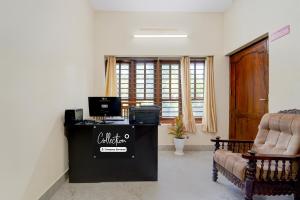an office with a desk with a computer and a couch at Super Collection O Technopark Phase 1 Formerly Snehalayam in Trivandrum