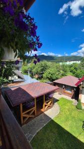 a picnic table in a garden with a view at Гори Вражень in Skole