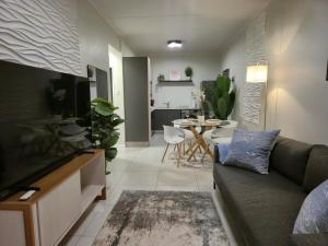 a living room with a couch and a table at The One Wave - 2 Bed Serenity meets Luxury in Midrand