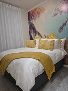 a bedroom with a large bed with yellow pillows at The One Wave - 2 Bed Serenity meets Luxury in Midrand