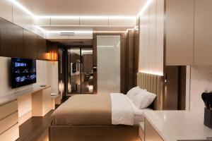 a bedroom with a bed and a television in it at Central one new apartments - panoramic skyline & boulevard in Tashkent