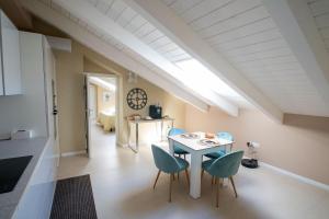 a kitchen and dining room with a table and chairs at Luxury Apartment Da Giovanni in Caserta