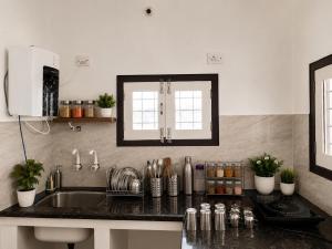 a kitchen with a sink and a counter top at SV Serenity Homestays in Gachibowli