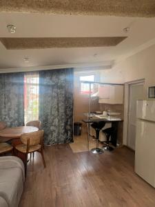 a living room with a couch and a table at Vato Apartment in Kobuleti