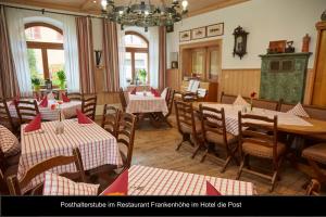 a restaurant with tables and chairs with red napkins at Ferienhäuser Ilsensee Schillingsfürst in Schillingsfürst +9 photos