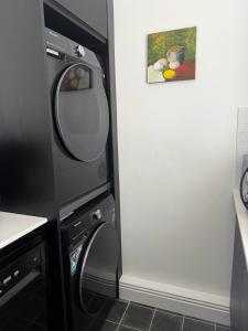 a kitchen with a washing machine and a mirror at The Old Parish Office! in Midleton