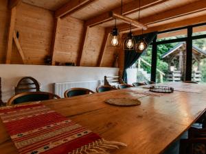 a large wooden table in a room with chairs at Cabana Aframe Blidari in Blidari