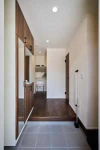 a hallway with a kitchen and a dining room at Black Grove House in Ginowan +35 photos