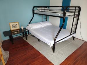 a bedroom with two bunk beds and a table at Blu Corner in Lian