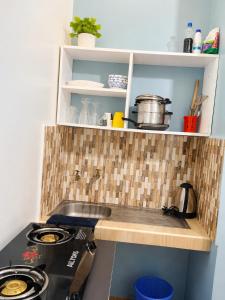 a kitchen with a stove and a counter top at Reenhomes in Kilifi