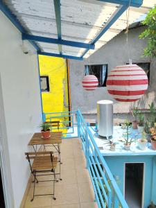 a patio with a table and chairs on a deck at Blu Corner in Lian