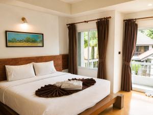 a bedroom with a large white bed with a window at See Through Resort Haad Yao in Haad Yao +64 photos