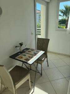 a table and chairs in a room with a window at wonderful sea view in Antibes