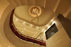 a spiral staircase with a chandelier in a building at Sona Pristine Hotel And Resort Ambala in Dhūlkot