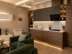 a living room with a couch and a kitchen at Vazi Aparthotel in Tbilisi City