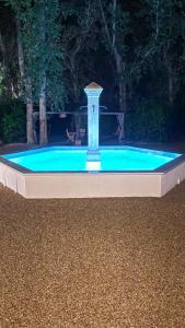 a small pool with a fountain in a yard at La Largarde in Six-Fours-les-Plages