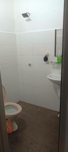 a bathroom with a toilet and a sink at Aisyhome in Jitra +3 photos