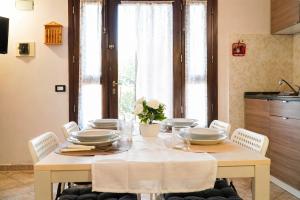 a dining room table with plates and dishes on it at Apartment between Pisa Lucca and Florence in Cascina