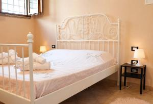 a white bed with white sheets and pillows on it at Apartment between Pisa Lucca and Florence in Cascina