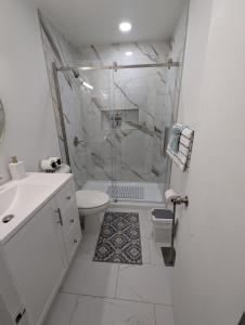 a white bathroom with a shower and a toilet at Fresh start small breakfast cook and serve your self in Lubbock +35 photos