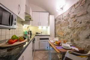 a kitchen with a table with fruits and vegetables on it at Casa Tamè - Happy Rentals in Melide