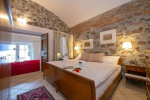 a bedroom with a large bed and a red couch at Casa Tamè - Happy Rentals in Melide