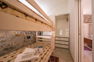 a bedroom with two bunk beds and a bathroom at Casa Tamè - Happy Rentals in Melide