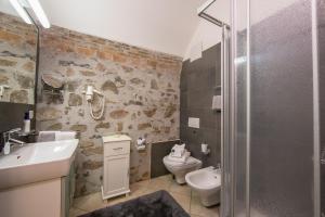 a bathroom with a sink and a toilet and a shower at Casa Tamè - Happy Rentals in Melide +30 photos