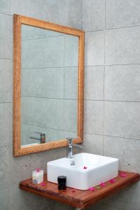 a bathroom with a white sink and a mirror at The lagoons resort Zanzibar in Nungwi +31 photos