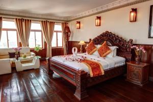 a bedroom with a large bed in a room at Okay Boutique Hotel in Phnom Penh +121 photos