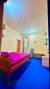 a bedroom with a red bed in a room at Lemon Tree Homestay Darjeeling in Darjeeling