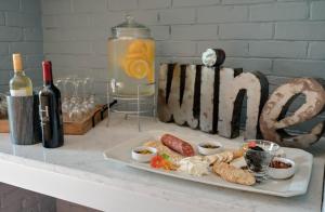 a plate of food on a table with a bottle of wine at Lakehouse Inn in Lee