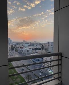 a view from a balcony of a city with traffic at Relaxing bed Ajman in Ajman 