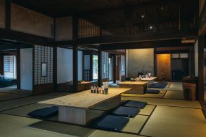 ein Raum mit Tischen und Matten in einem Gebäude in der Unterkunft Hotel Raccan in Shibushi