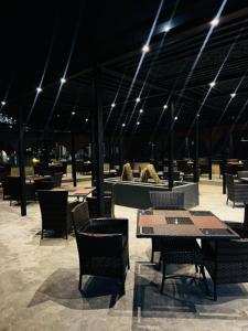 a restaurant with tables and chairs and lights at Burj A Zafar in Murree