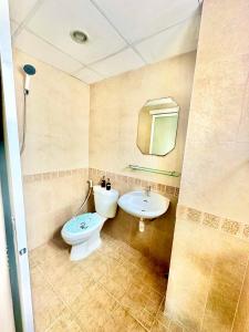 a bathroom with a toilet and a sink at P ratunam Residence Hotel in Bangkok