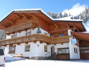 a house in the mountains with snow at Gästehaus Brix in Kelchsau