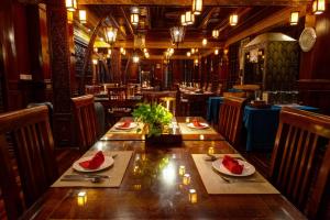 a dining room with a table with watermelons on it at Okay Boutique Hotel in Phnom Penh