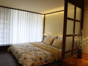 a bedroom with a bed with a large window at Smile Home in Hanoi