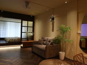 a living room with a couch and a tv at Smile Home in Hanoi