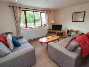 a living room with two couches and a table at Valley View in Cleator Moor