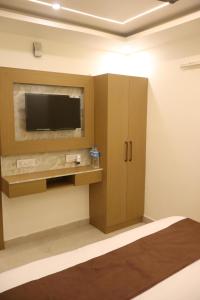 a room with a flat screen tv on a wall at SS Residency in Gorakhpur