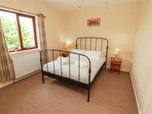a bedroom with a bed and a window at Valley View in Cleator Moor