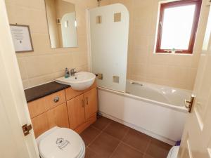 a bathroom with a sink and a toilet and a bath tub at Valley View in Cleator Moor +14 photos